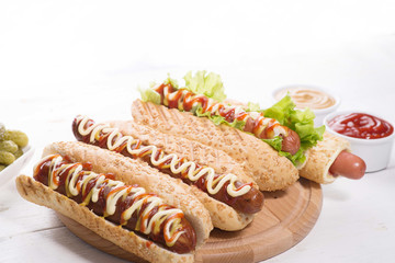 many different hot dogs with sauces on the table