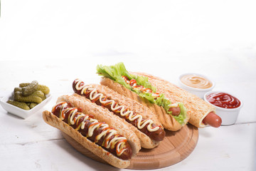 many different hot dogs with sauces on the table