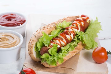 hot dog with sauces on a plate