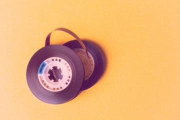 reel music tapes on a yellow background