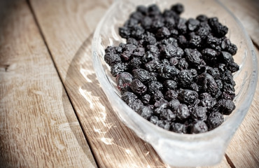 Healthy forest berries, dry chokeberry - aronia in glass bowl