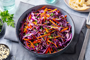 Red cabbage salad. Coleslaw in a bowl. Grey background. Close up. - 266595719