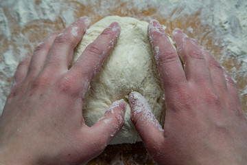 Fototapeta premium chef kneads dough for pizza with his hands 