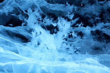 Sun rays are refracted by the transparent ice of Lake Baikal. cracks at different depths create a bizarre web