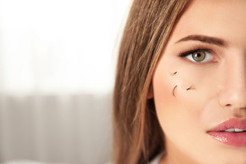 Young woman with fallen eyelashes on her face indoors. Space for text