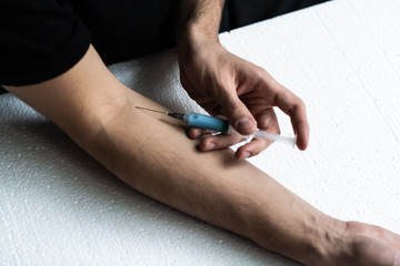 Drug addict male doing himself an injection. Drug Abuse. self-medication.