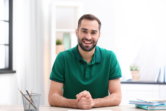 Handsome man using video chat for conversation indoors
