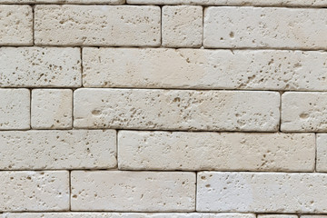 White stone brick wall tiles surface, close-up exterior background 