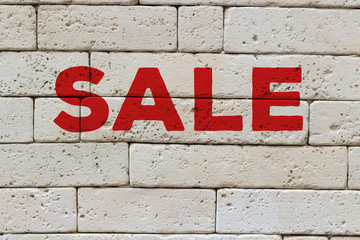 Sale marketing banner red letters advertisement on a white brick wall front view, online banner ad with copy space