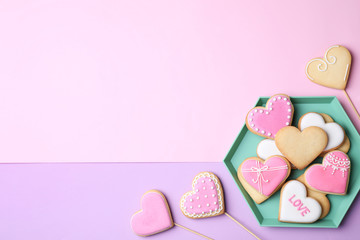 Flat lay composition with heart shaped cookies on color background. Space for text