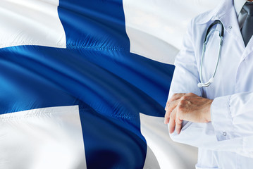Finnish Doctor standing with stethoscope on Finland flag background. National healthcare system...