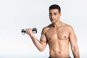 Fototapeta na wymiar handsome mixed race man with shirtless muscular torso holding dumbbell on white
