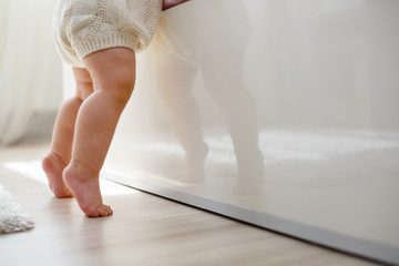 First steps of a child in his room with natural light.