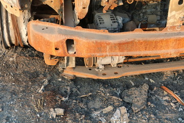 burnt out car dumped by the side of the road