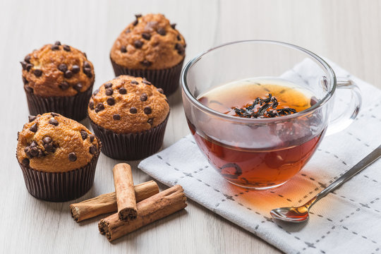 Cup of tea with muffins and cinnamon