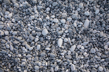 Light gray pebbles of the beach in the Kiparissi Lakonia village, Peloponnese, Zorakas Bay, Greece.
