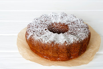 Fototapeta na wymiar Homemade vanilla bunt cake on white wooden desk.