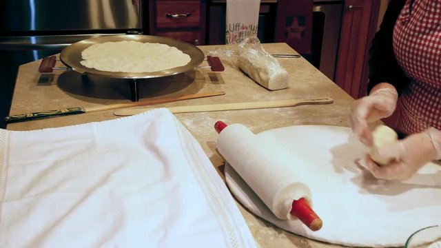 Making Lefse, the delicious traditional soft Norwegian flatbread, made with potatoes, flour, butter and cream and cooked on a large flat griddle. Time lapse.