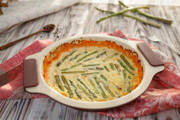 Homemade omelet with aspargus in on wooden table