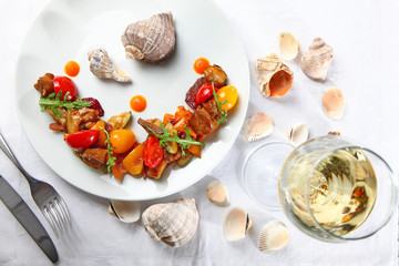 Salad from vegetables and rapanov meat. Meat shells rapanov from the Sea of Azov. Grilled vegetables with a great sauce. Blackberry top view. Still life concept.