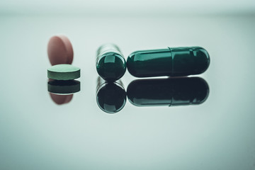 Different types of multi-colored pills. Photographed closeup of pharmaceuticals.