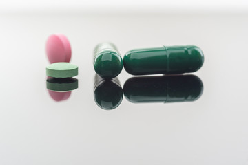 Different types of multi-colored pills. Photographed closeup of pharmaceuticals.