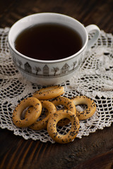 Bagels with cup of tea on a wooden board.