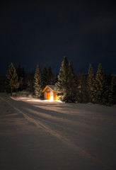 Small cabin in the winter forest
