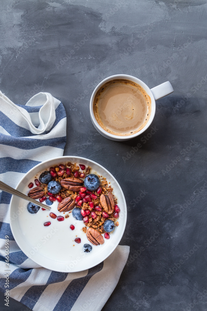 Poster Granola, muesli with pomegranate seeds, blueberries and yogurt