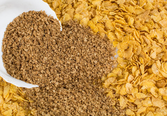 Buckwheat flakes poured from a plate of cornflakes