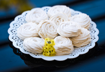 marshmallow in a white plate on a dark background
