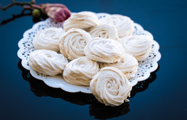 marshmallow in a white plate on a dark background