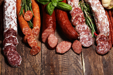 cold meat assortment with delicious salami and  fresh herbs . Variety of meat products including coppa and sausages