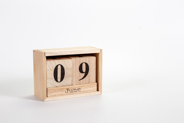 Wooden calendar June 09 on a white background