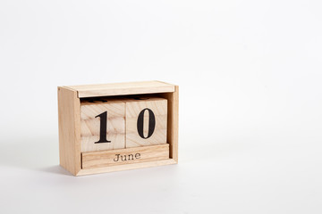 Wooden calendar June 10 on a white background