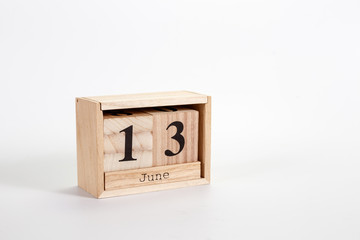 Wooden calendar June 13 on a white background