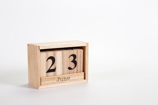 Wooden calendar June 23 on a white background