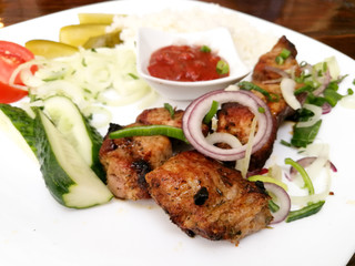 Armenian dish shashlik served in plate on the restaurant table