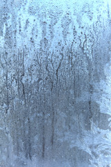 Frost on the glass. The frozen water. Winter background