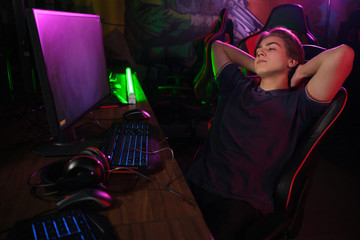 Cyber sport. Rrelaxed player rests in the break between matches on his comfortable gaming chair © nazarovsergey