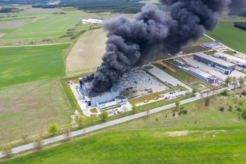 Aerial view of burnt industrial warehouse or logistics center building after big fire with huge...
