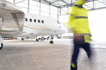 Airport workers check an aircraft for safety in a hangar