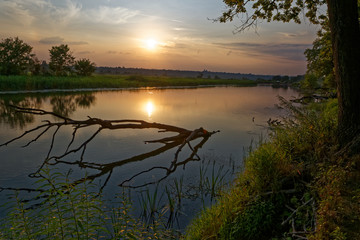 Fototapeta na wymiar Colorful sunset over the river suburban area of central Russia.