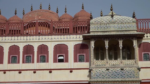 Wide shot of the ornate balcony and rooftop above the southwest lotus gate in City Palace in Jaipur, India