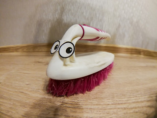 Old bristle broom with crazy eyes