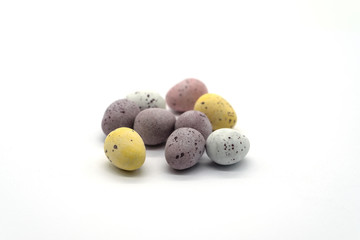 Miniature Chocolate Eggs in a Pile on a White Background