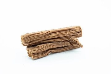 A Logs of Flaky Chocolate on a Plane White Background
