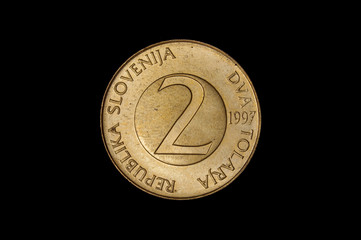 2 tolar old Slovenian coin isolated on the dark background