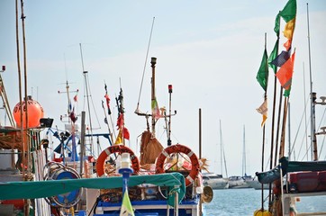 Boats and flags in harbour in Trapani, Sicily