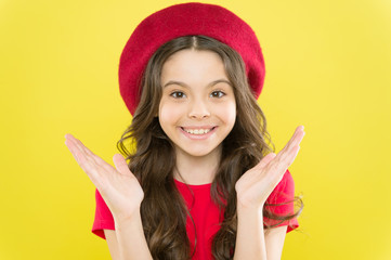 Styling of curly hair. Hairdresser service. Kid girl long healthy shiny hair. Perfect curls. Kid cute face with adorable curly hairstyle wear beret hat. Little fashionista. Little girl grow long hair